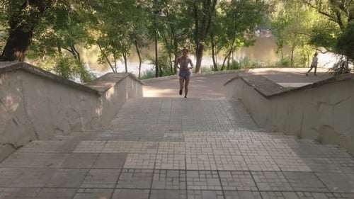 Woman Runs Up Park Stairs for Exercise