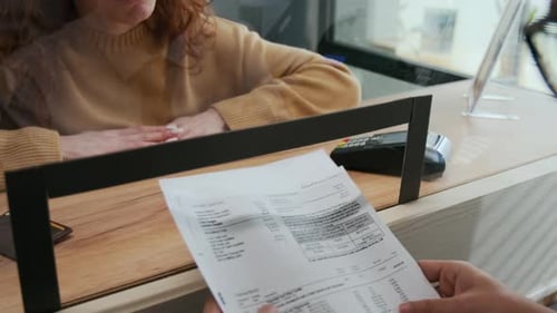 Confused Woman Asking Bank Teller to Help her with Document Issue