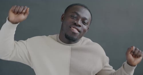 Slow Motion Portrait of Happy African American Man Dancing Looking at Camera