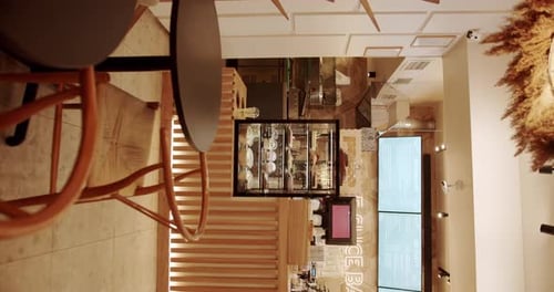 Modern Minimalist Cafe with Wooden Chair with Textile Material and Black Table