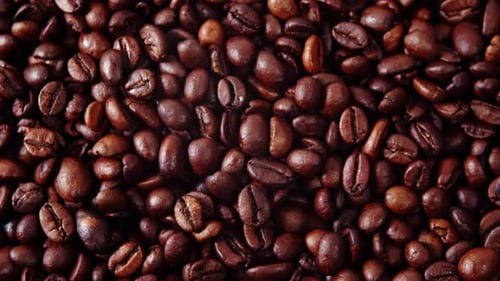 Top View of Coffee Beans Rotating in a circleBackground of Roasted Coffee Beans