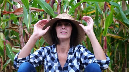 Female Tired Agronomist Sitting After Hard Work Near Maize Field Adult Beautiful Farmer in Straw Hat