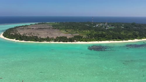 Aerial view of tropical island paradise with lagoon and beach, Maldives.