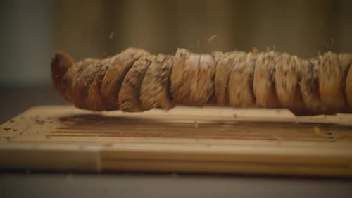 Multigrain Bread Slices Falling on Cutting Board
