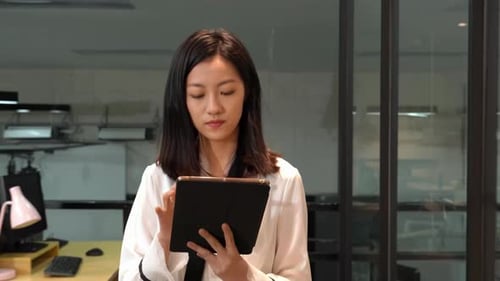 Confident business woman walking in office, using touchpad computer for work Busy professional