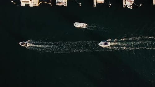 Boats navigating through calm waters near a marina