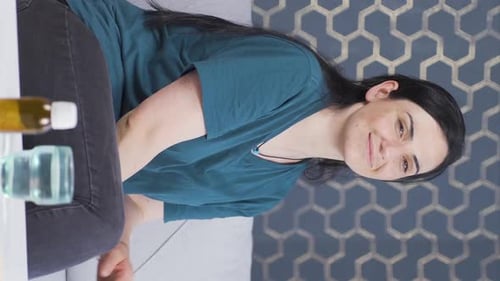 Smiling Woman Sitting on Sofa at Home