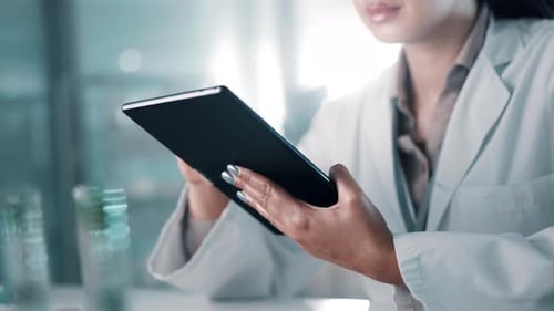 Woman Scientist Using Tablet in Modern Lab