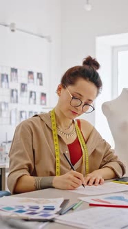 Zoom in Shot of Inspired Fashion Designer Working at Workshop Sketching New Models Slow Motion