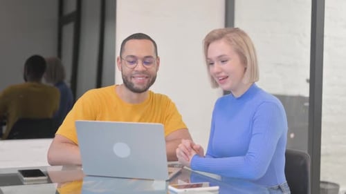Young Adults In Office At Laptop Video Call