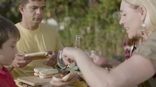 Family Enjoys Outdoor Barbecue on a Sunny Day