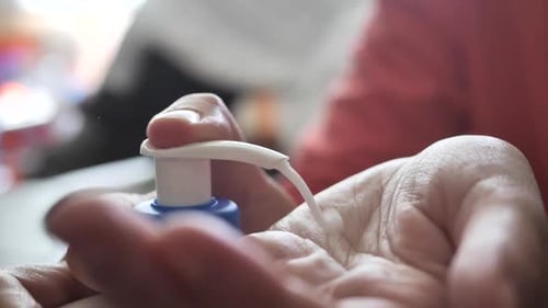 Dispensing White Lotion into Hand for Skincare