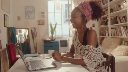 Smiling Woman Video Conferencing at Home Office
