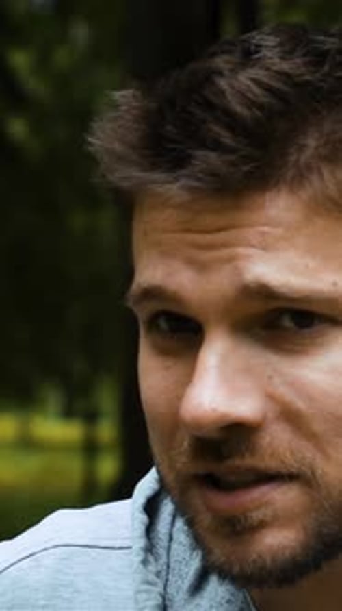 Vertical of Road Runner Caucasian Man Running Talking By Phone with Bluetooth Headset Handsfree