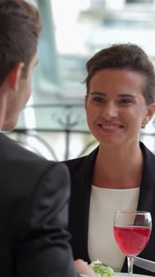 Dynamic Young Professionals Sharing a Vibrant Business Lunch at a Chic Restaurant