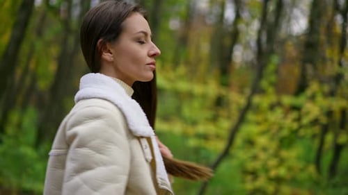 Woman Walking in the Park in Fall