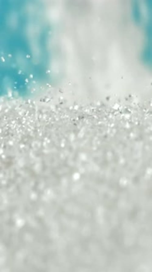 Sugar Falling in a Pile on a Blue Background Filmed on a Highspeed Camera at 1000 Fps