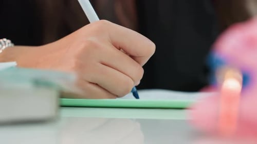 Close Up of Teenager Writing with Blue Pen