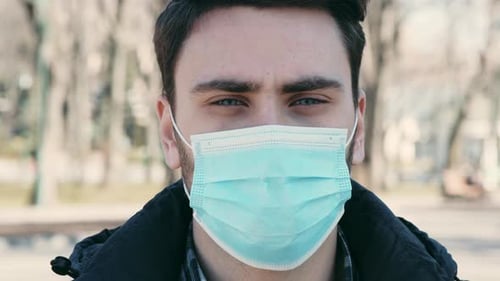 Young Guy Wearing Protective Mask Standing Alone in Park