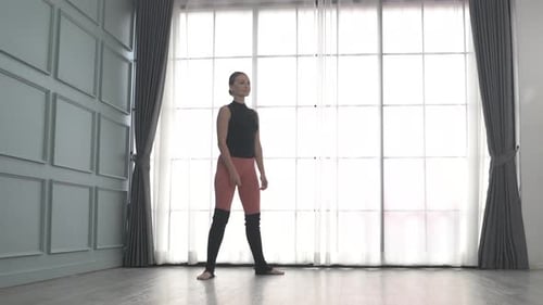 Friends practice ballet dance at studio.