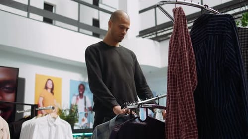 Middle Eastern Customer Explores the Latest Fashion Collection at a Mall Store