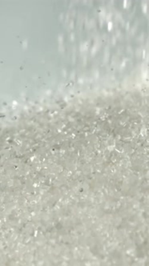 Sugar Falls on the Table in a Heap Filmed on a Highspeed Camera at 1000 Fps