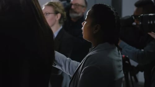 Woman Gives Press Conference to Video Camera Crowd