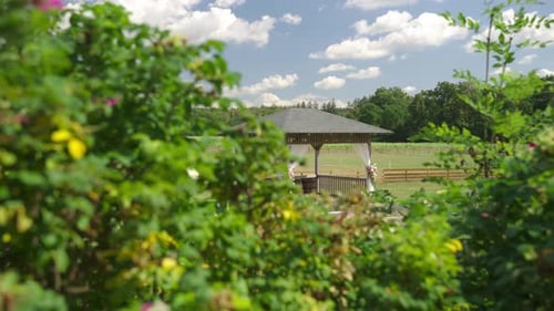 Wedding altar set up in a gazebo outdoors on a farm, beautifully decorated with flowers as preparati