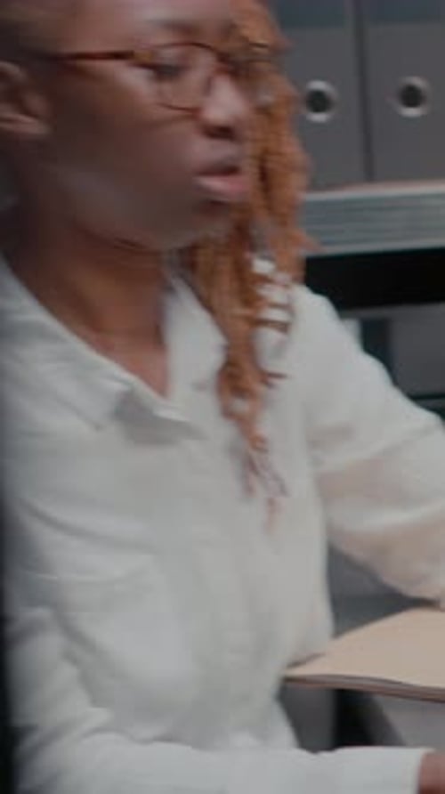 Woman Typing On Laptop In Office Setting