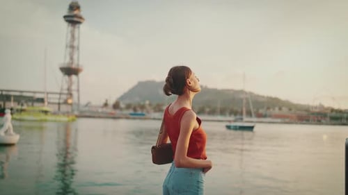 Close-up, girl stands on the seashore and looks at the bay