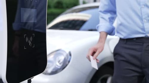 Progressive Man Pay for Charging Point to Power Rechargeable Electric Vehicle