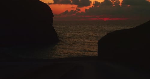 Dramatic Orange Sunset With Calm Ocean From Chapel Porth Beach In United Kingdom. - wide static