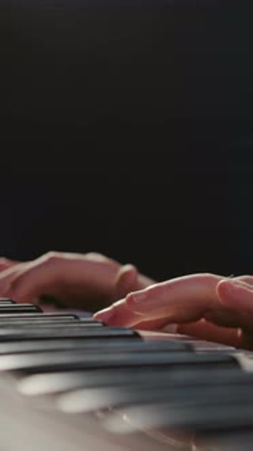 Hands Play Piano in Indoor Setting