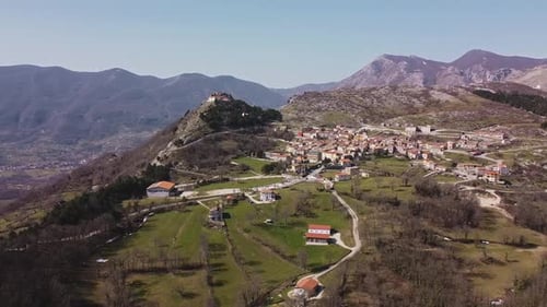 Aerial panoramic landscape view of Pietraroja, a hill top village in Italy, on a bright sunny day
