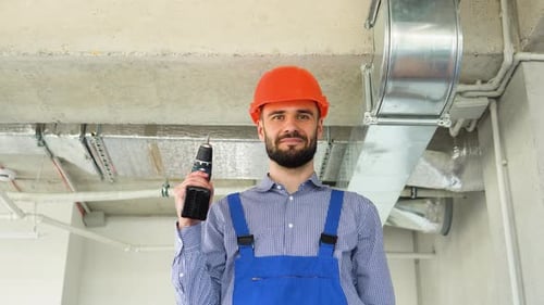 Man Holding Cordless Drill in Workplace Environment