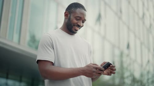 Man Using Smartphone Outside Urban Building