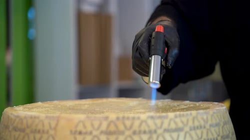 Hand Melting Cheese with Torch Close Up