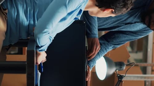 Two Adults Work Together in Warehouse Setting