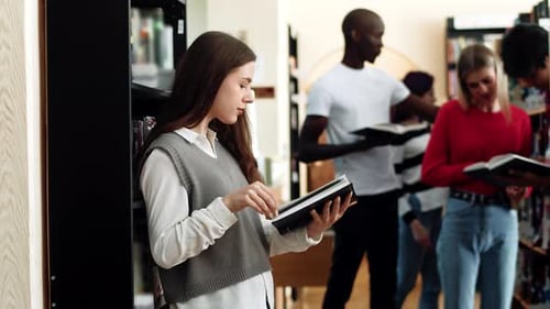 Woman Student with Long Hair in College Library Read Book Smart and Thoughtful Young Female Student