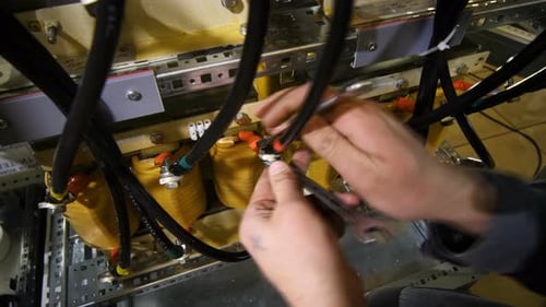 Close up of Hands Working on Complex Wiring