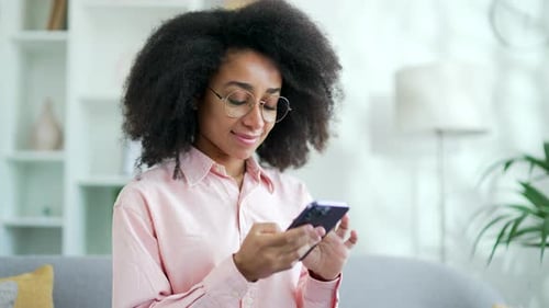 Woman Using Mobile Phone in Home Setting