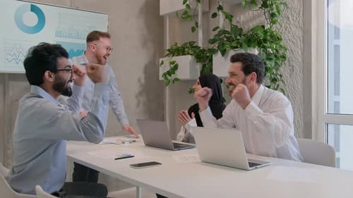 Business Team Celebrates Success in Modern Office