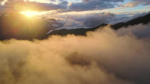 Sun Shines Through Clouds Over Mountain Landscape Creating a Calm Atmosphere