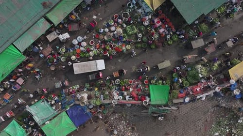 Aerial view of busy street market with colorful stalls, Bangladesh.