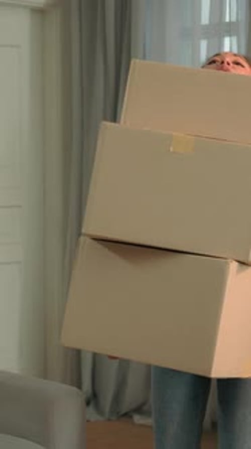 Tired woman drops boxes in modern apartment