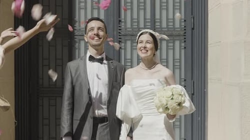 Happy Couple Celebrates Wedding Day With Flower Petals