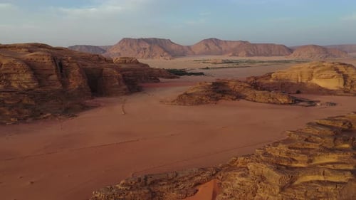Wadi Rum red desert landscape at sunset, Jordan, aerial pull away