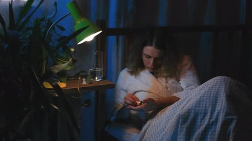 Woman Taking Medicine Before Sleeping in Bed