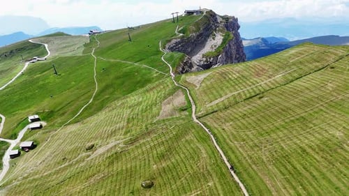 Camera approaching mountain top with hikers