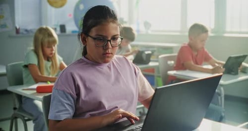 Team of Smart Diverse Kids Working on Their Laptops and Tablet Computers Studying Basic Programming